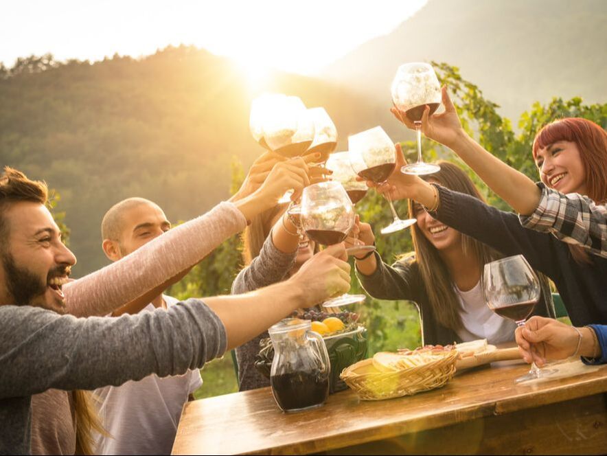 large group on mountain top drinking wine